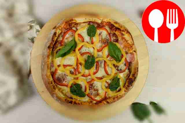 Homemade pizza with ham, smoked sausage and bell pepper