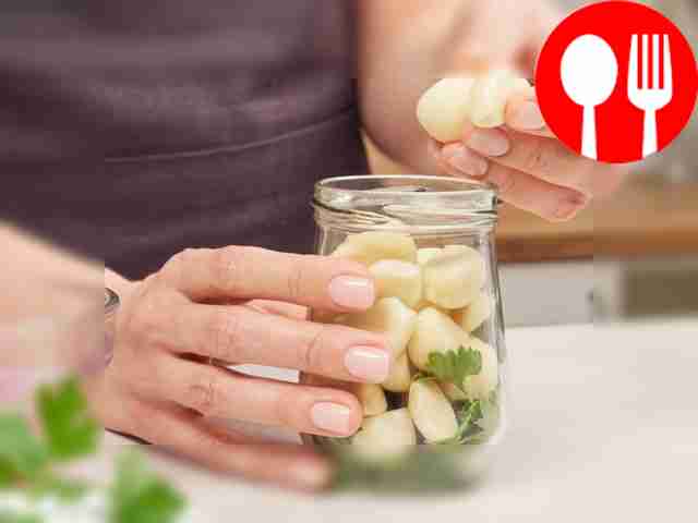 Fill the jar with garlic and spices. Place...