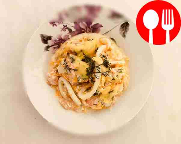 Place squid with fish fillet on a plate. Top...