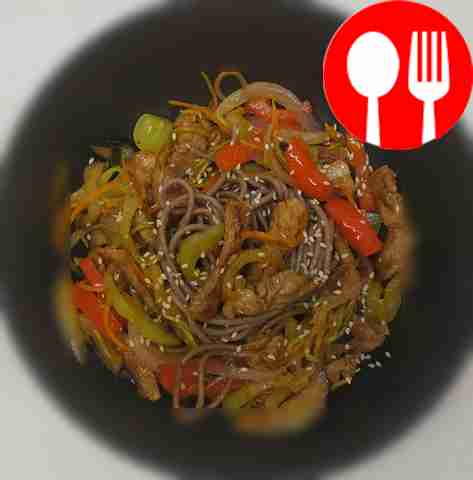 Pork with buckwheat wok noodles in sweet and sour sauce