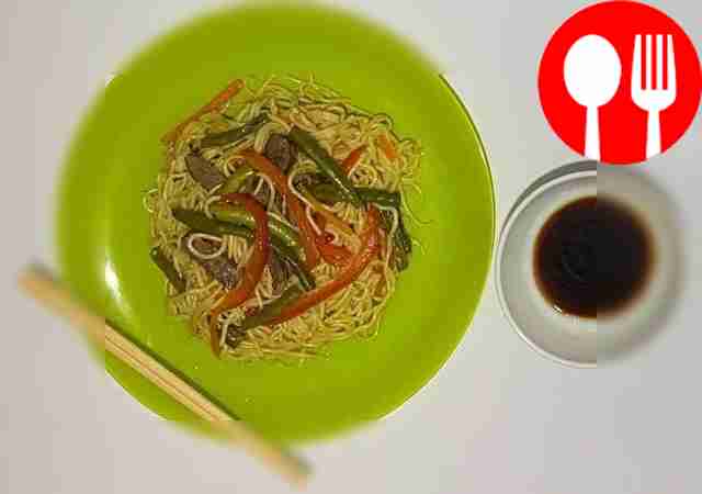 Appetizing egg noodles with beef and vegetables in oyster sauce