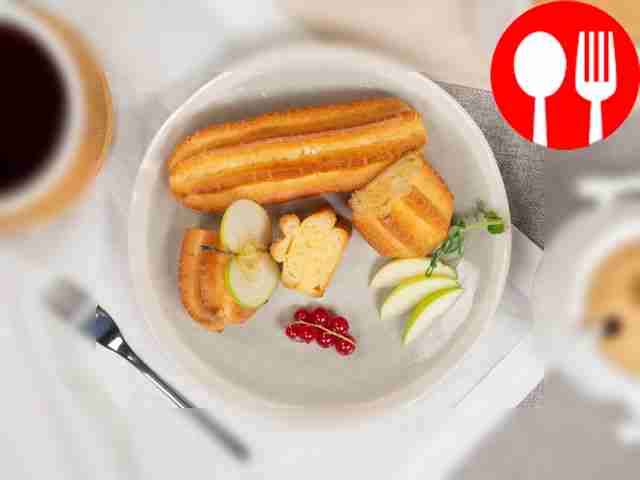 Before serving, drizzle homemade eclairs with...