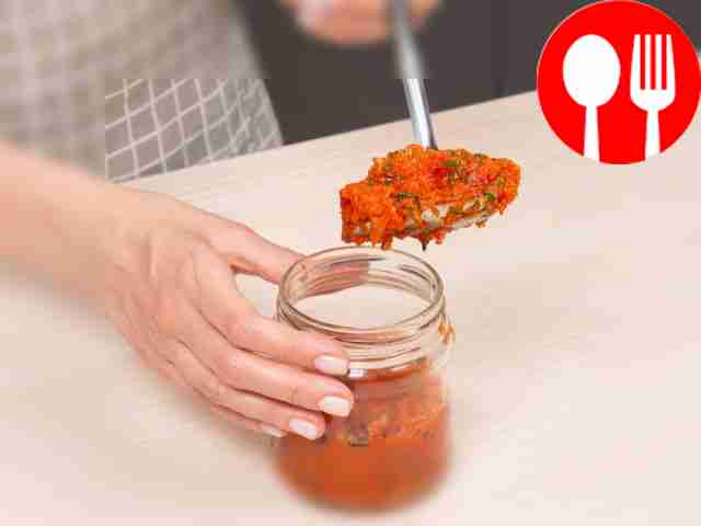 Pour adjika into jars. While the Armenian...