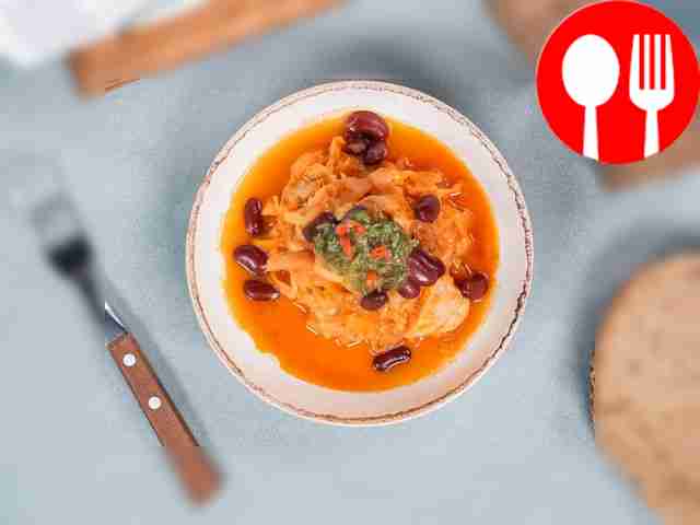 Place the finished stewed chicken with cabbage...