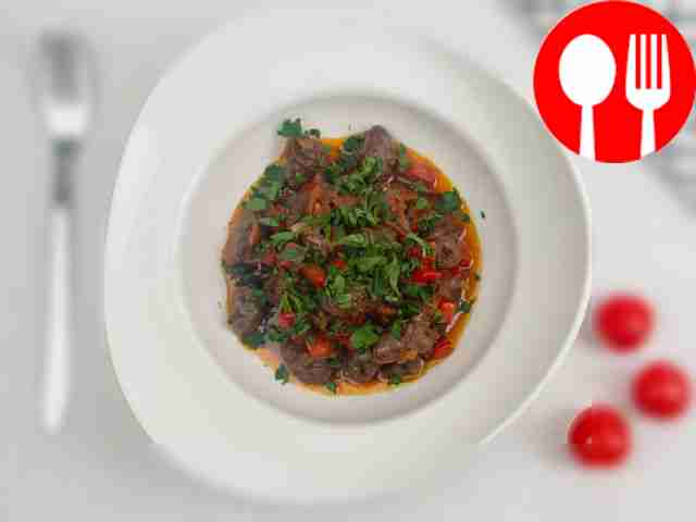 Подавайте горячие куриные сердечки с овощами,...