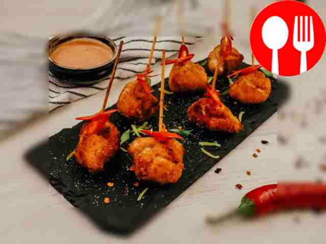 Canapes with chicken and prunes, fried in breadcrumbs