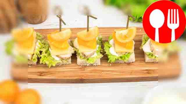 Canapes with chicken, orange and cherry tomato