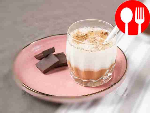 Place the glass of cocktail on a plate, the...