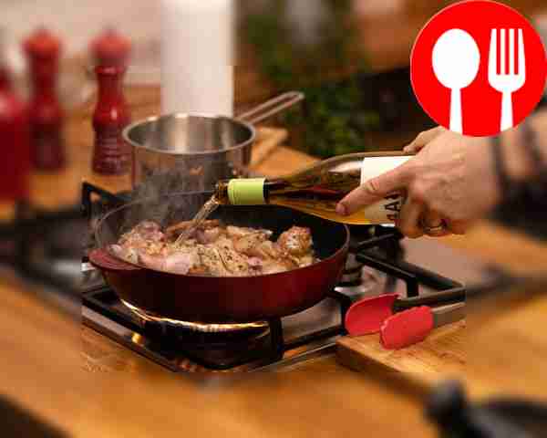 Add white wine, garlic cloves in their skins...