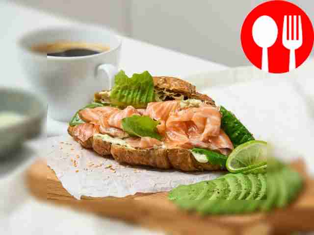 Healthy croissant with avocado and salmon