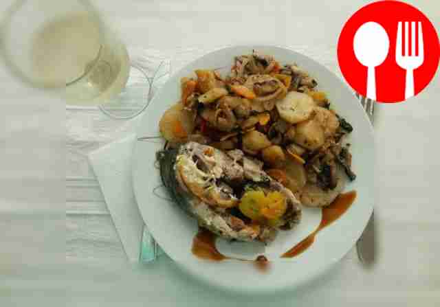 Stuffed carp baked with vegetables in a sleeve