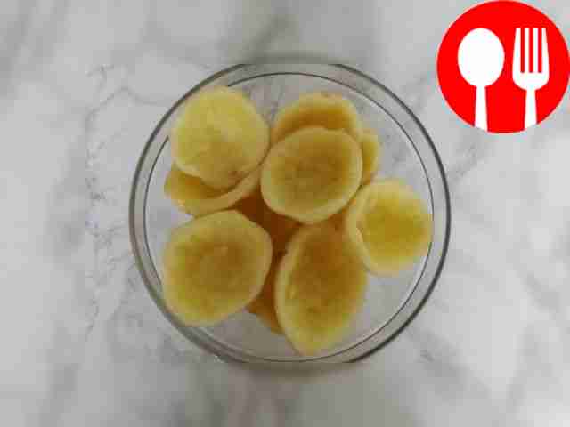 Cut the peeled potatoes in half and cut out...