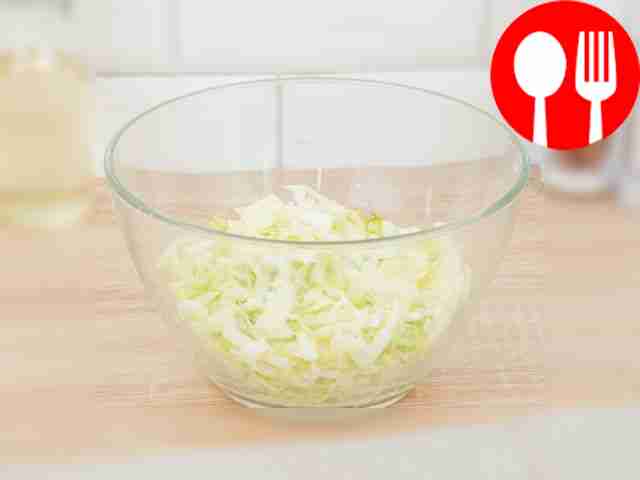 Place the cabbage in a deep bowl and lightly...