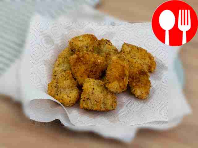Place cooked nuggets on paper towels to remove...