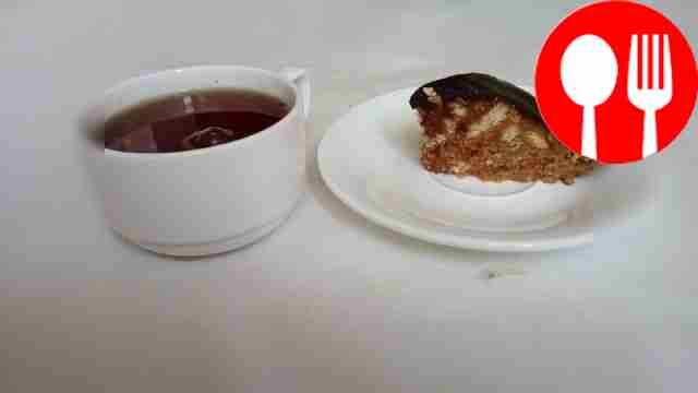 Cut the frosted cake with nuts into portions....