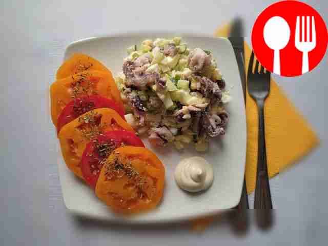 Hearty octopus salad with egg and fresh cucumbers