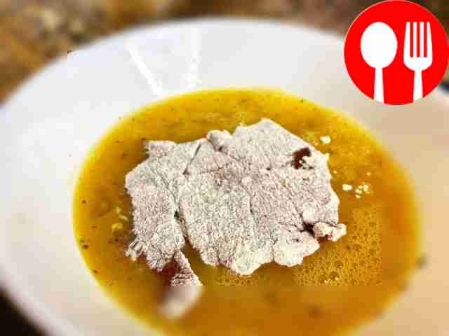 Roll the liver pieces in flour, then dip them...