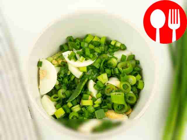 Add chopped green onions to the soup.