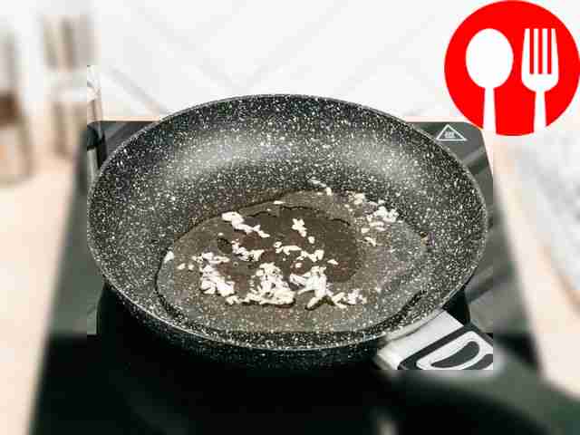Add chopped garlic to the oil heated in a...