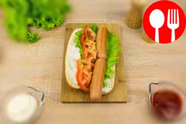 Place lettuce and two sausages on the bun.